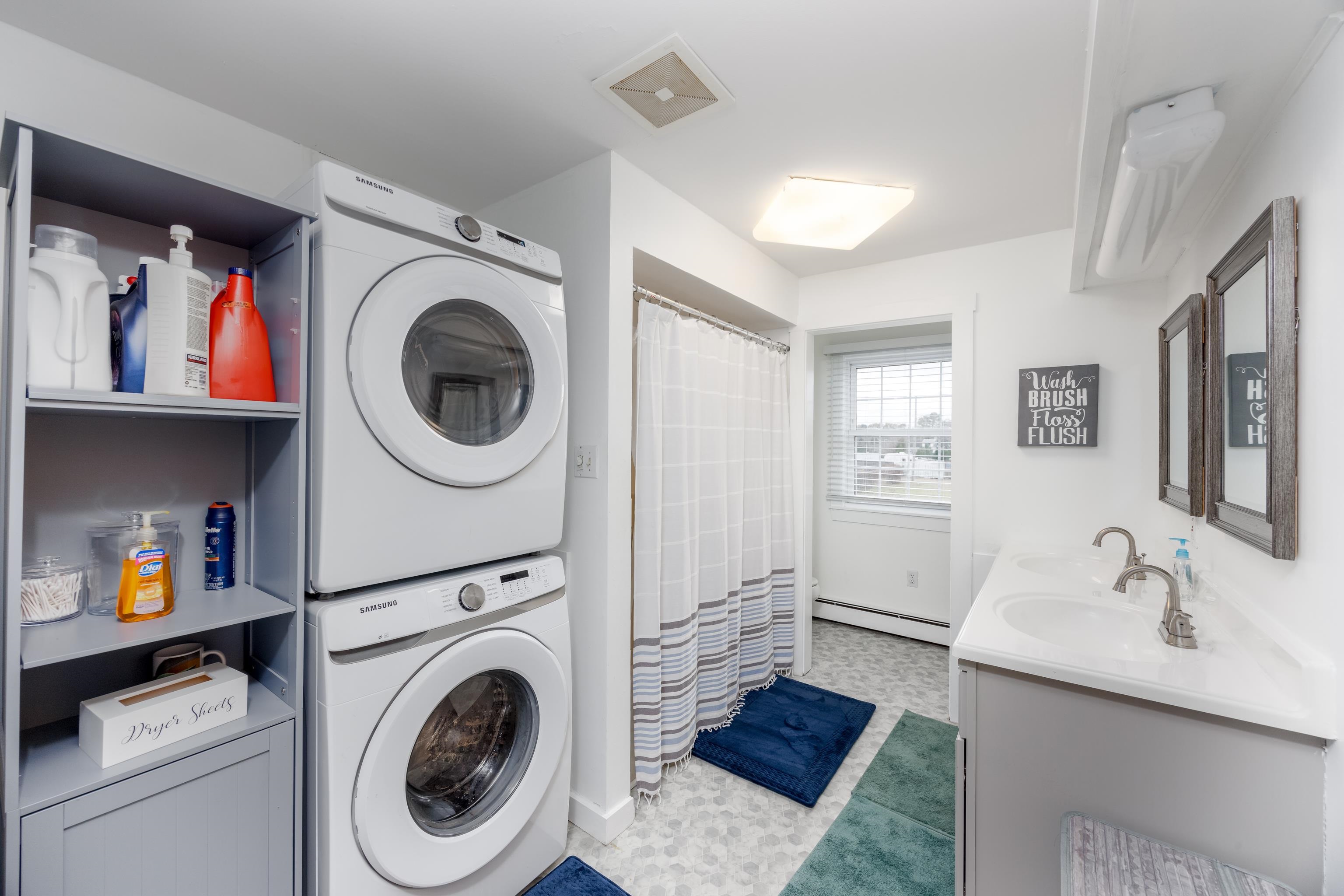 103 Bate Avenue Rio Grande, NJ 08242 - Photo 27 of 50 a bathroom with a sink a mirror and a washer dryer