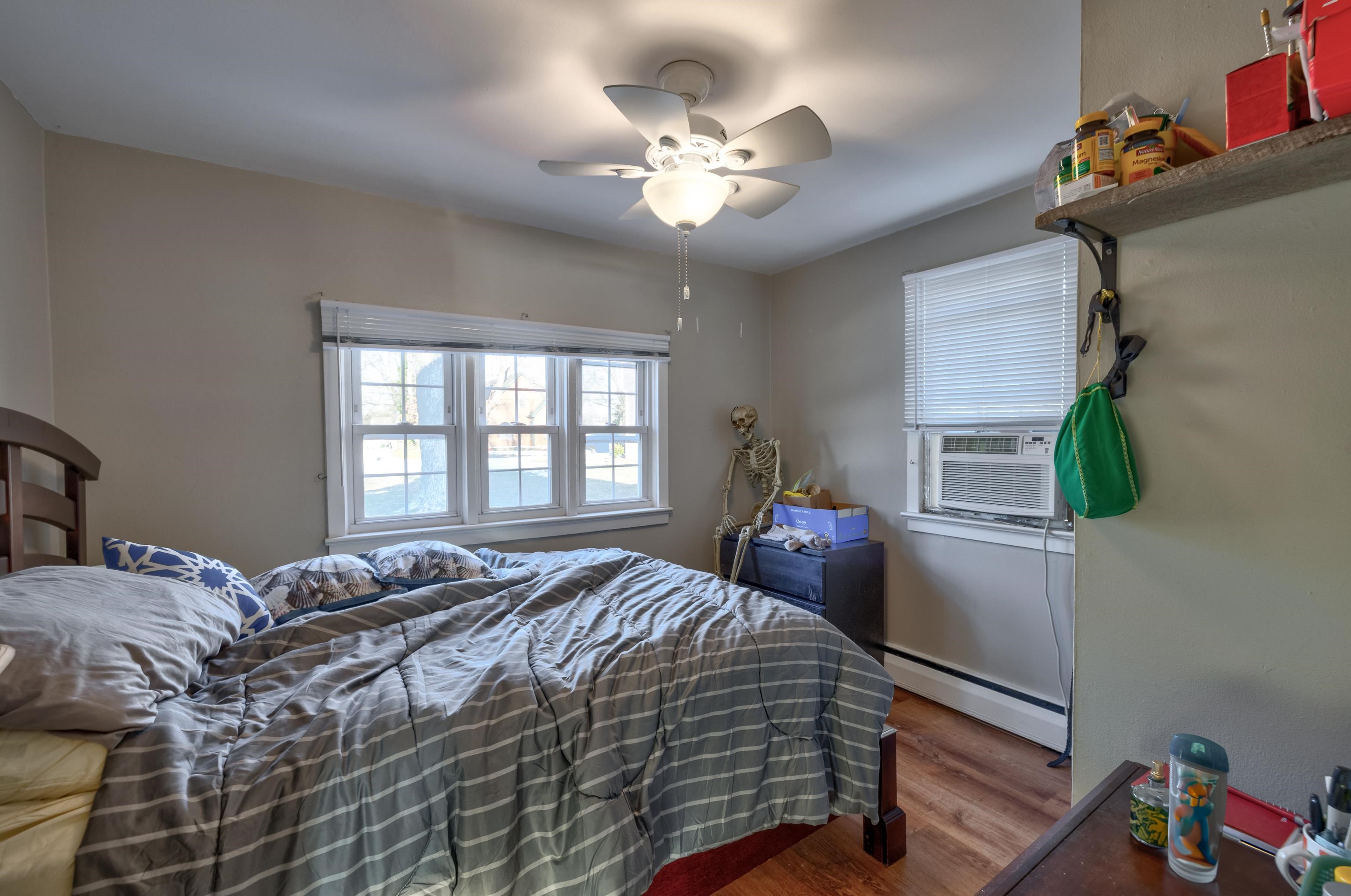 103 Bate Avenue Rio Grande, NJ 08242 - Photo 45 of 50 a bedroom with a bed and a chandelier