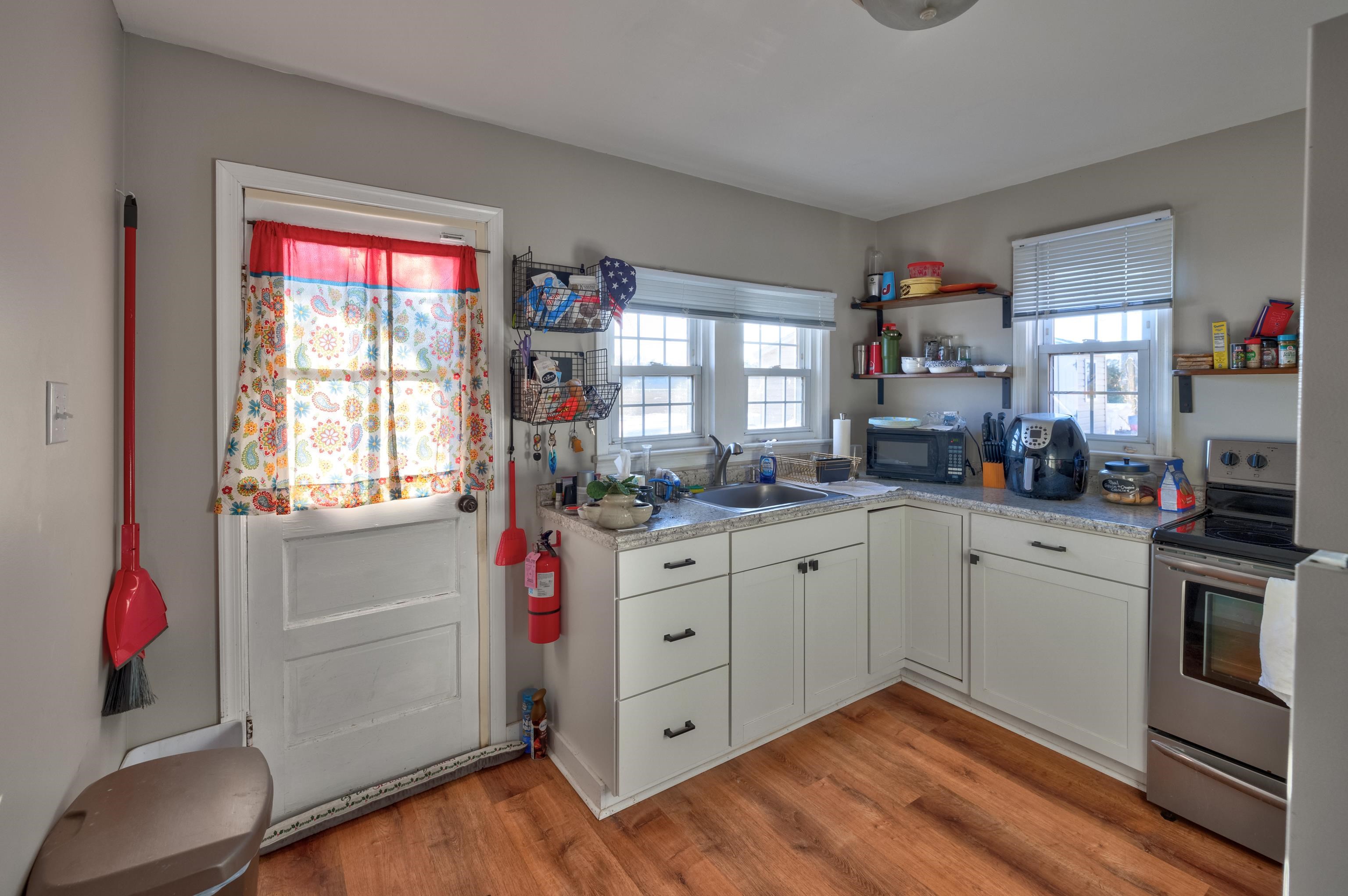 103 Bate Avenue Rio Grande, NJ 08242 - Photo 47 of 50 a kitchen with white cabinets and white appliances