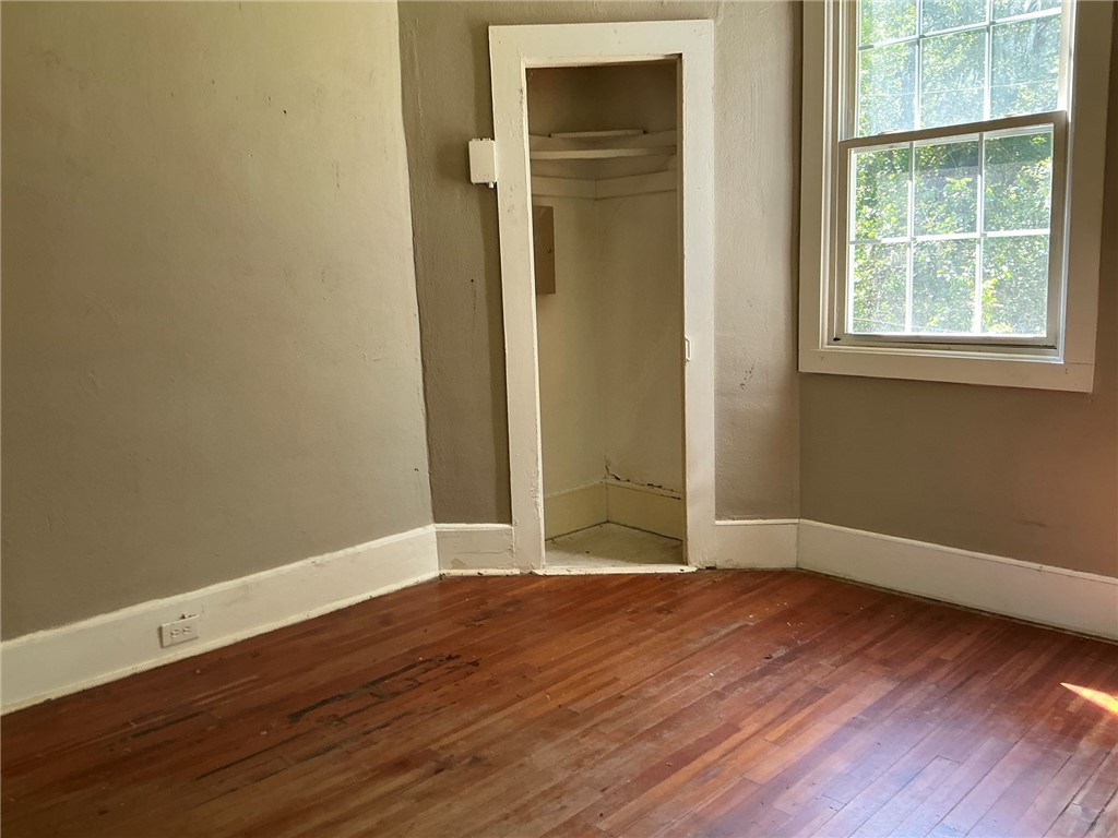 14 Ames Street Seneca, SC 29678 - Photo 10 of 15 This cozy bedroom offers rich hardwood floors and a bright window, creating a serene living space.