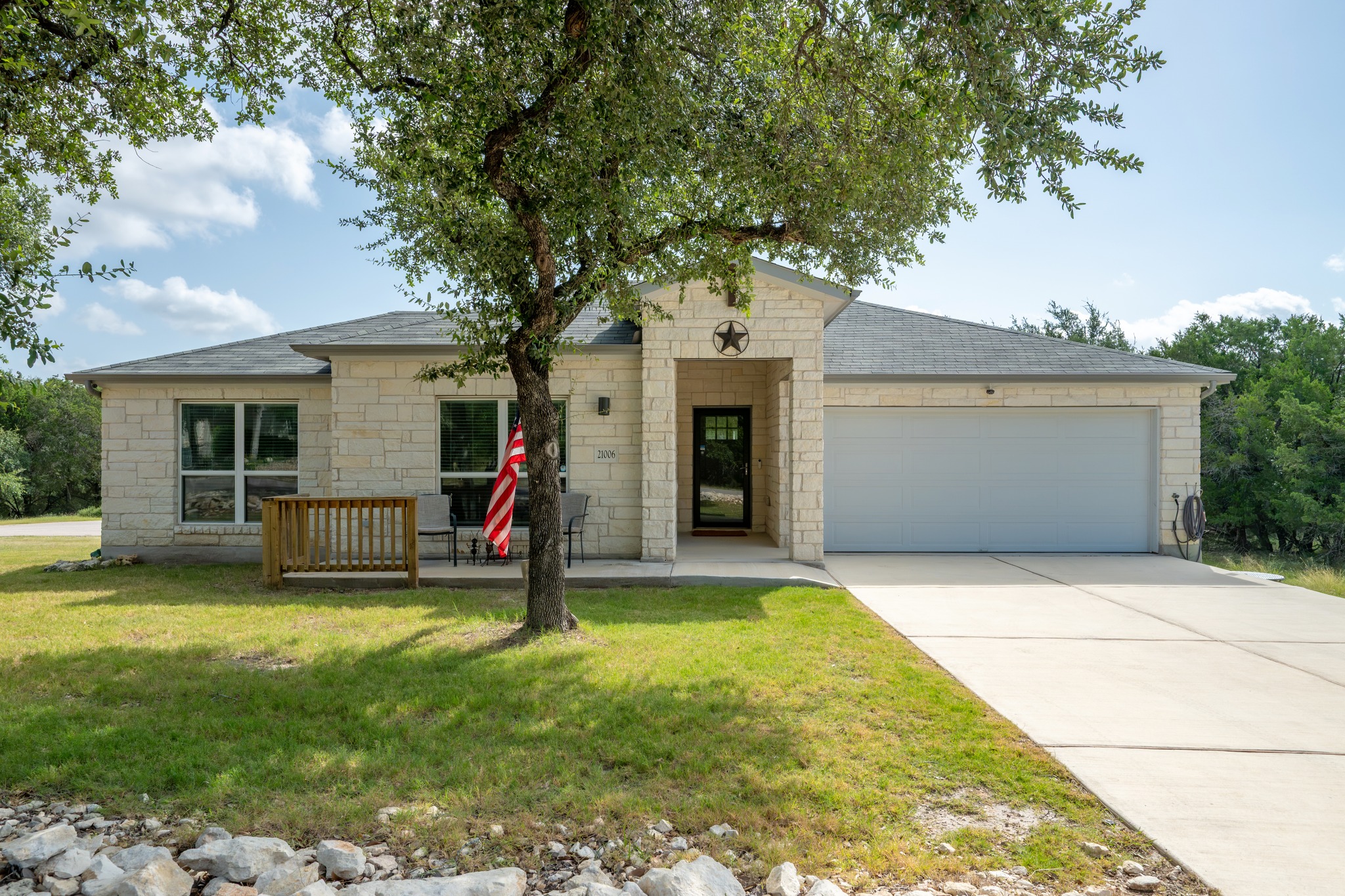 21006 Santa Rosa Avenue Lago Vista, TX 78645 - Photo 1 of 26 A welcoming stone facade with a covered entry and attached garage defines this charming property.