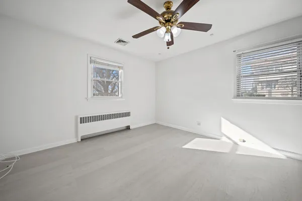 a view of an empty room with a ceiling fan