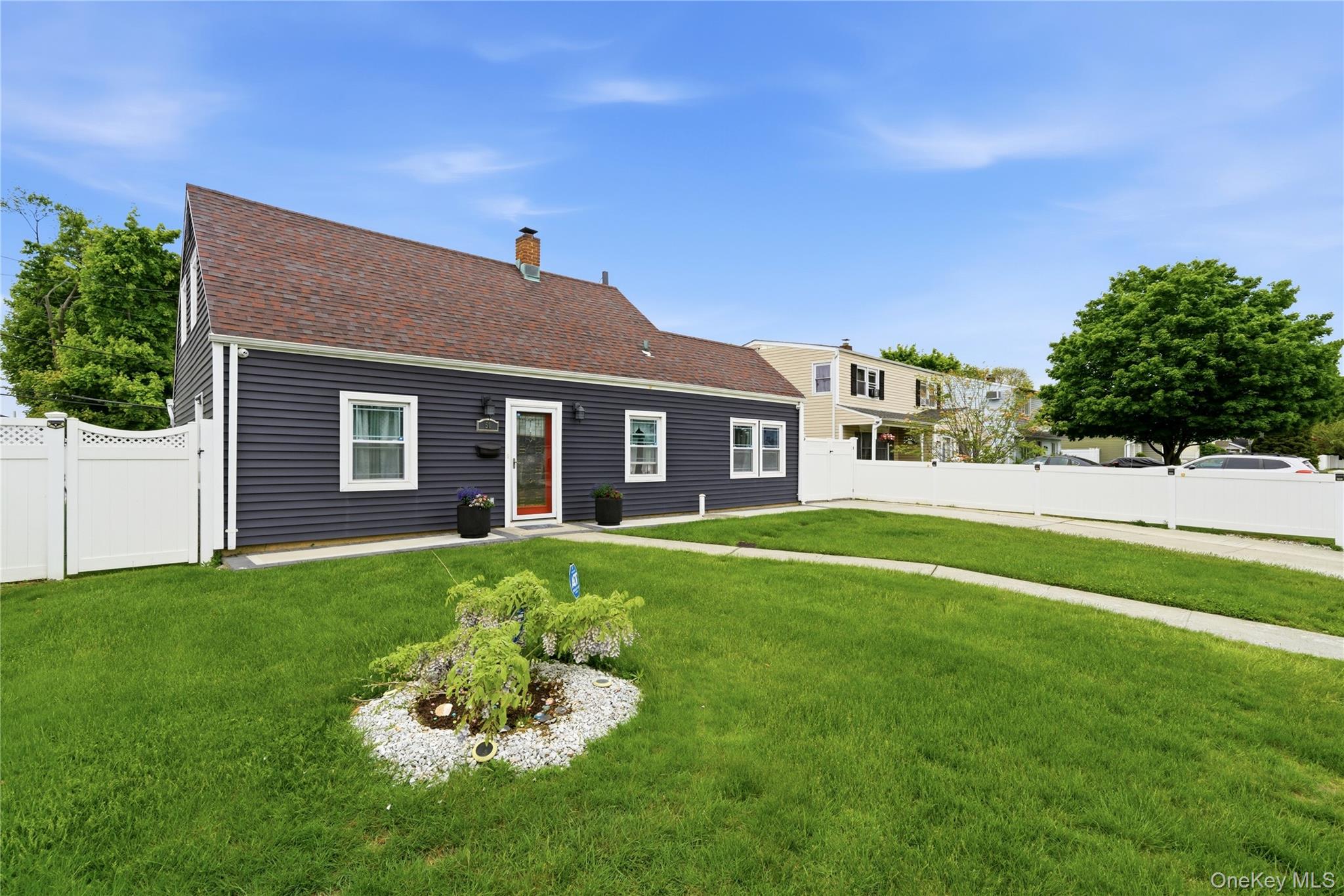 50 Ridge Lane Levittown, NY 11756 - Photo 2 of 27 a front view of a house with a yard