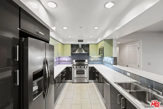 a kitchen with stainless steel appliances granite countertop a sink and stove