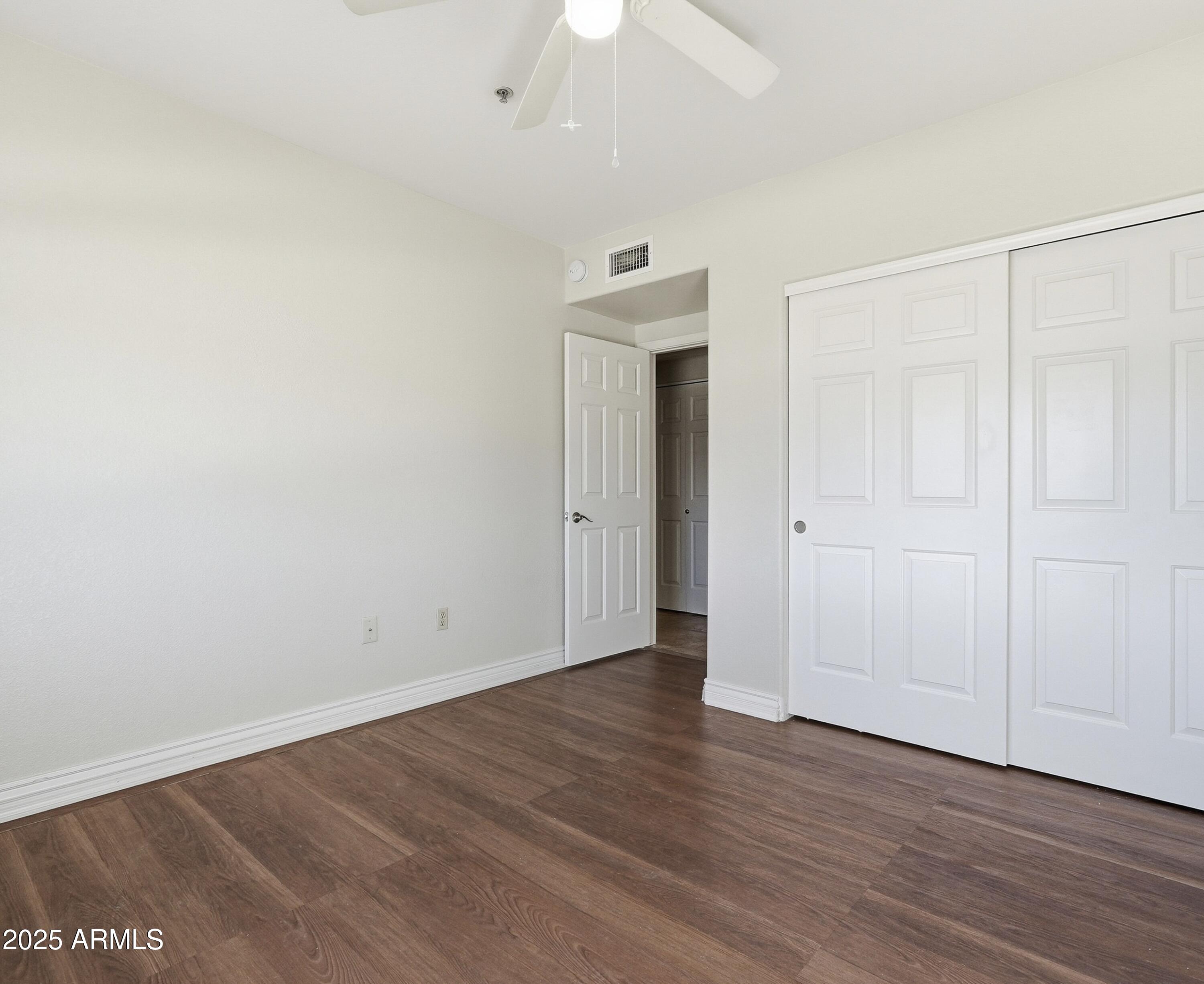 1825 West Ray Road, Unit 2145 Chandler, AZ 85224 - Photo 14 of 25 wooden floor in an empty room