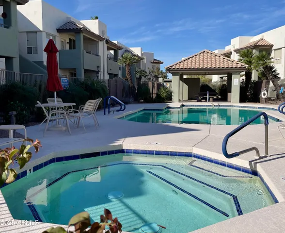 a view of a patio with table and chairs potted plants