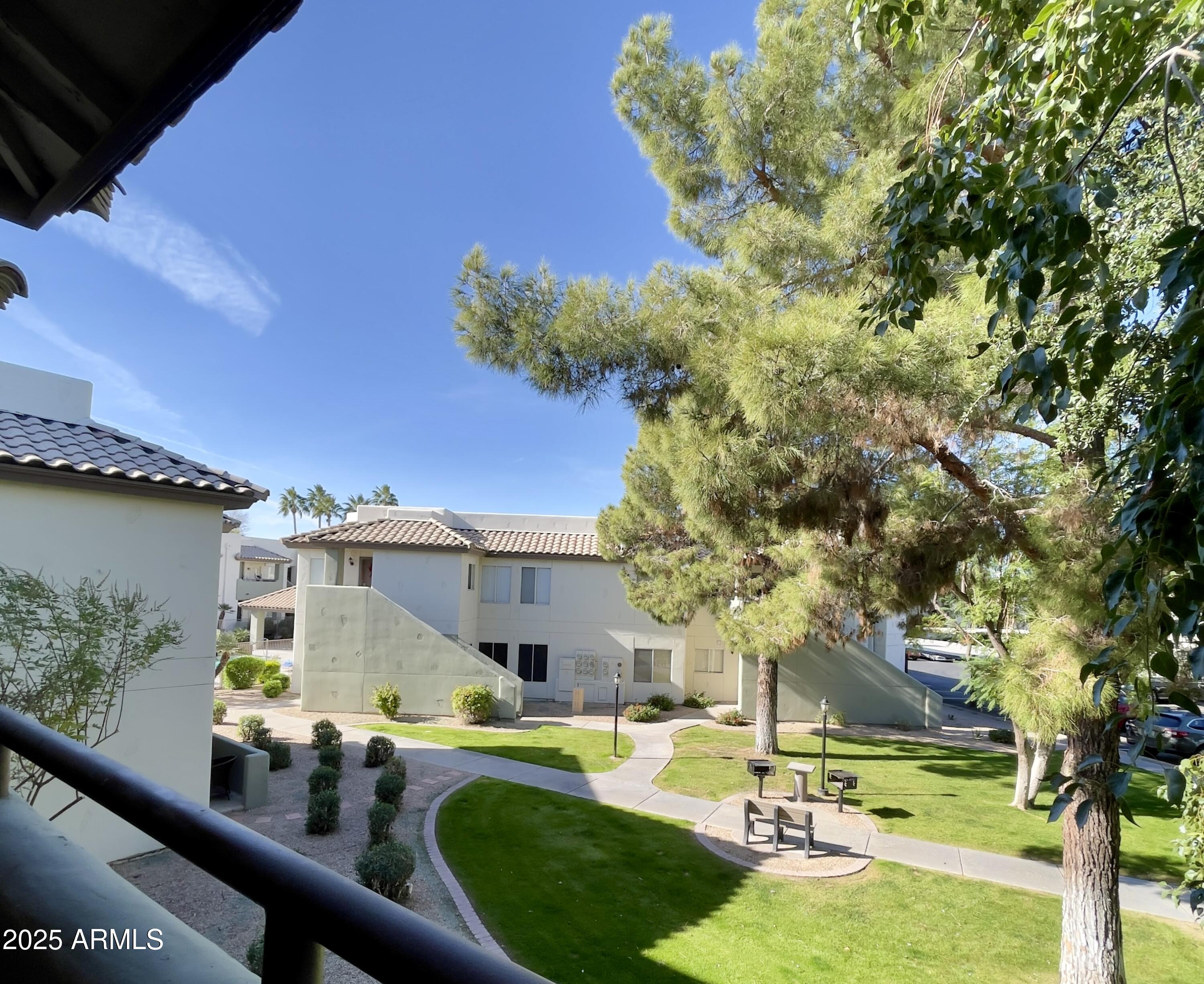 1825 West Ray Road, Unit 2145 Chandler, AZ 85224 - Photo 18 of 25 a swimming pool with outdoor seating and yard