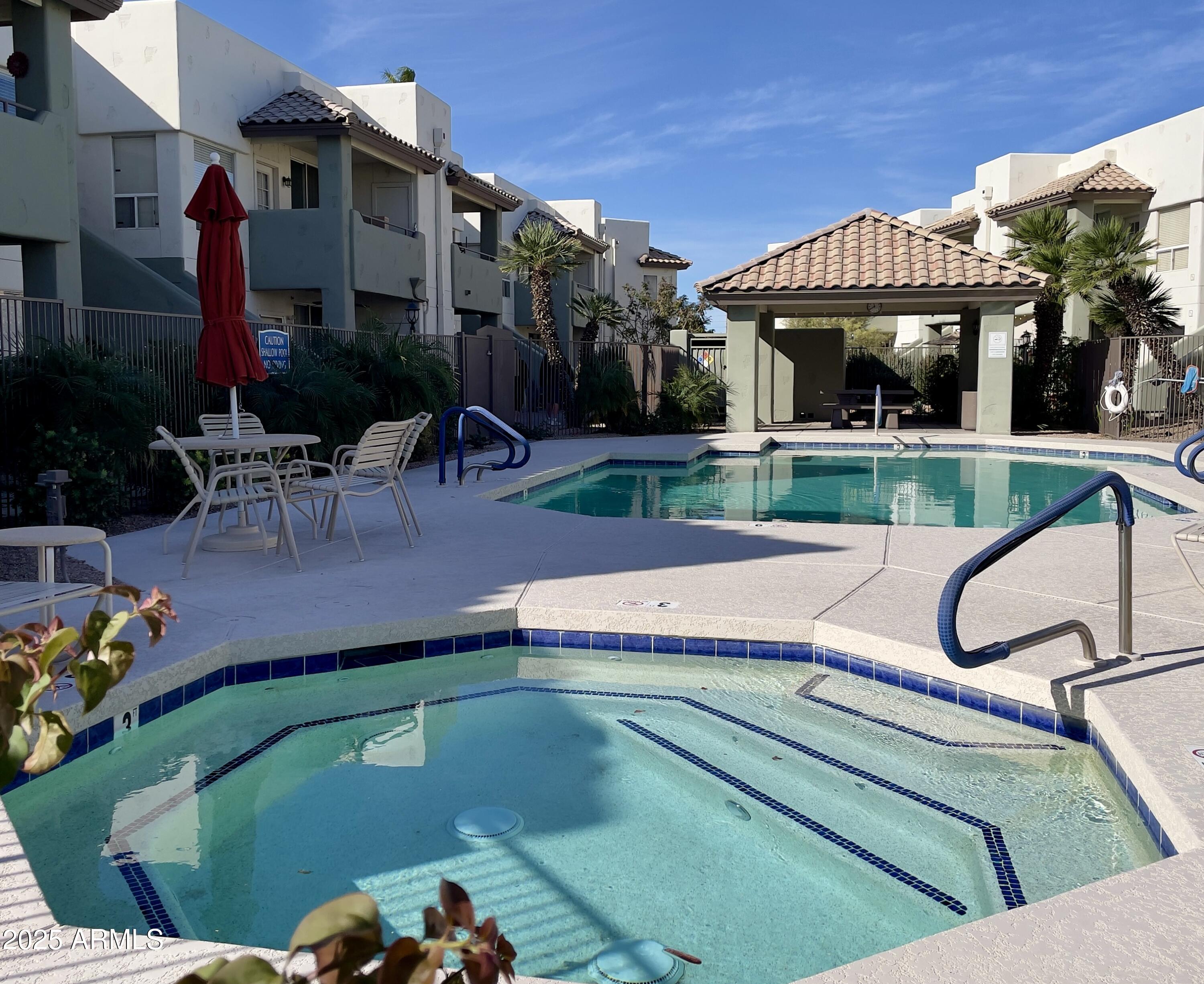 1825 West Ray Road, Unit 2145 Chandler, AZ 85224 - Photo 20 of 25 a view of a patio with table and chairs potted plants