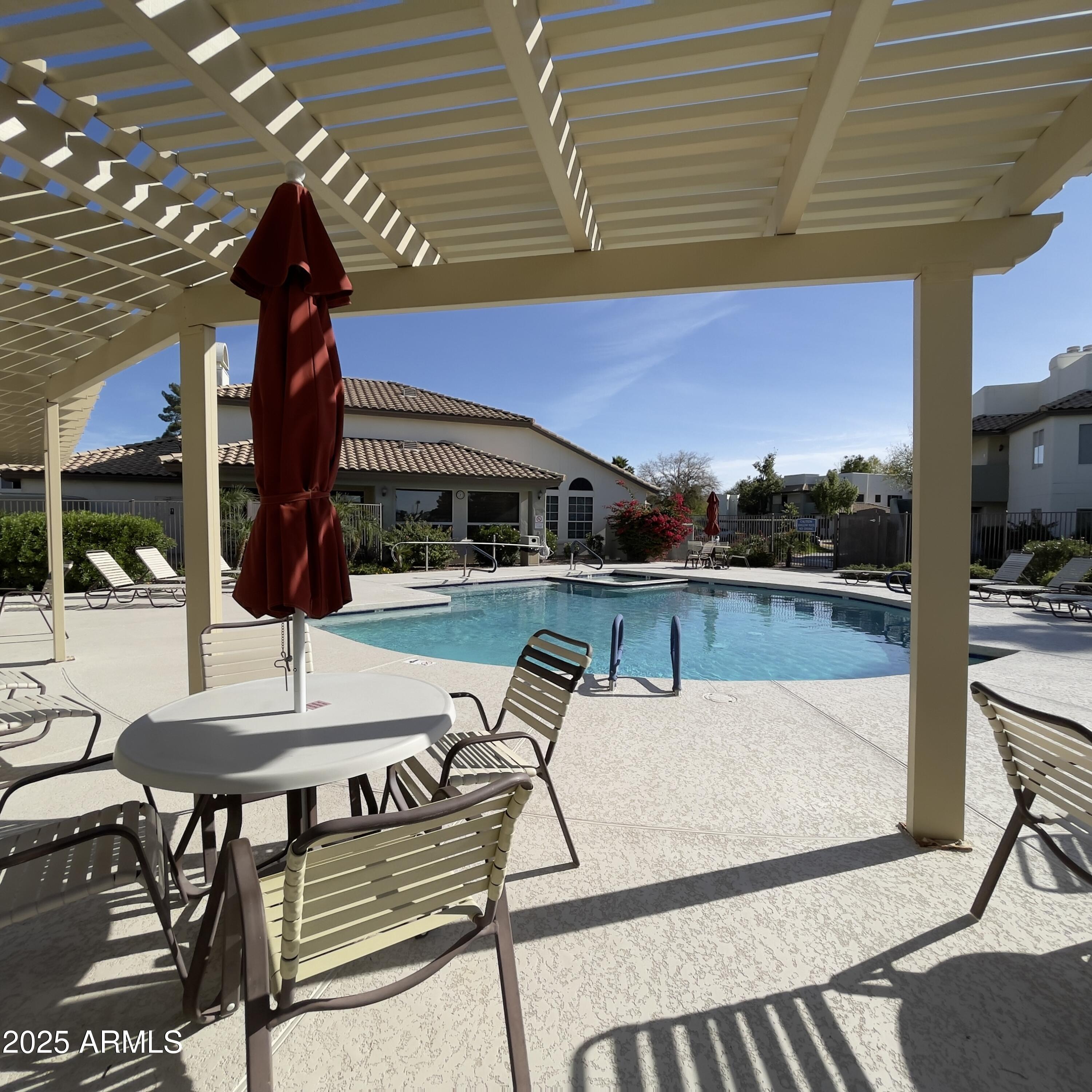 1825 West Ray Road, Unit 2145 Chandler, AZ 85224 - Photo 23 of 25 a view of a patio with chairs and potted plants