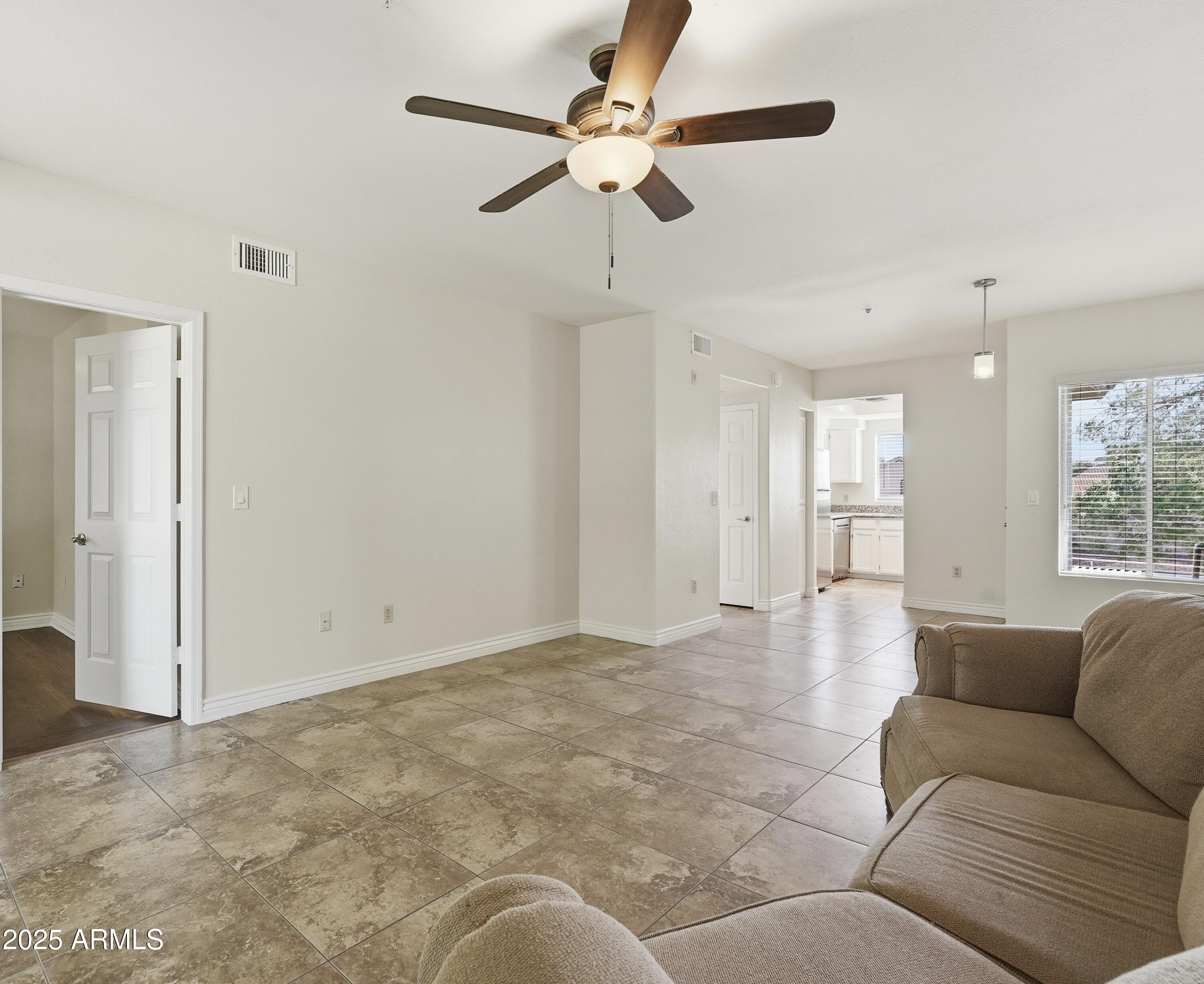 1825 West Ray Road, Unit 2145 Chandler, AZ 85224 - Photo 6 of 25 a living room with furniture and a ceiling fan