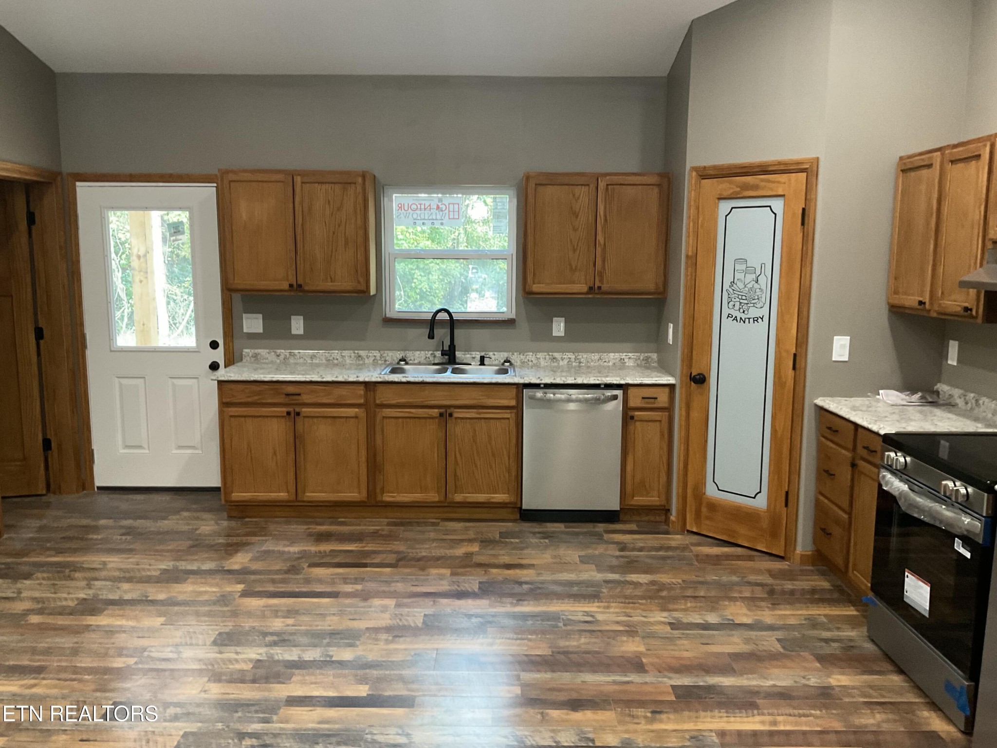 246 Burkemill Road Rockwood, TN 37854 - Photo 2 of 24 a kitchen with stainless steel appliances granite countertop a sink stove and refrigerator