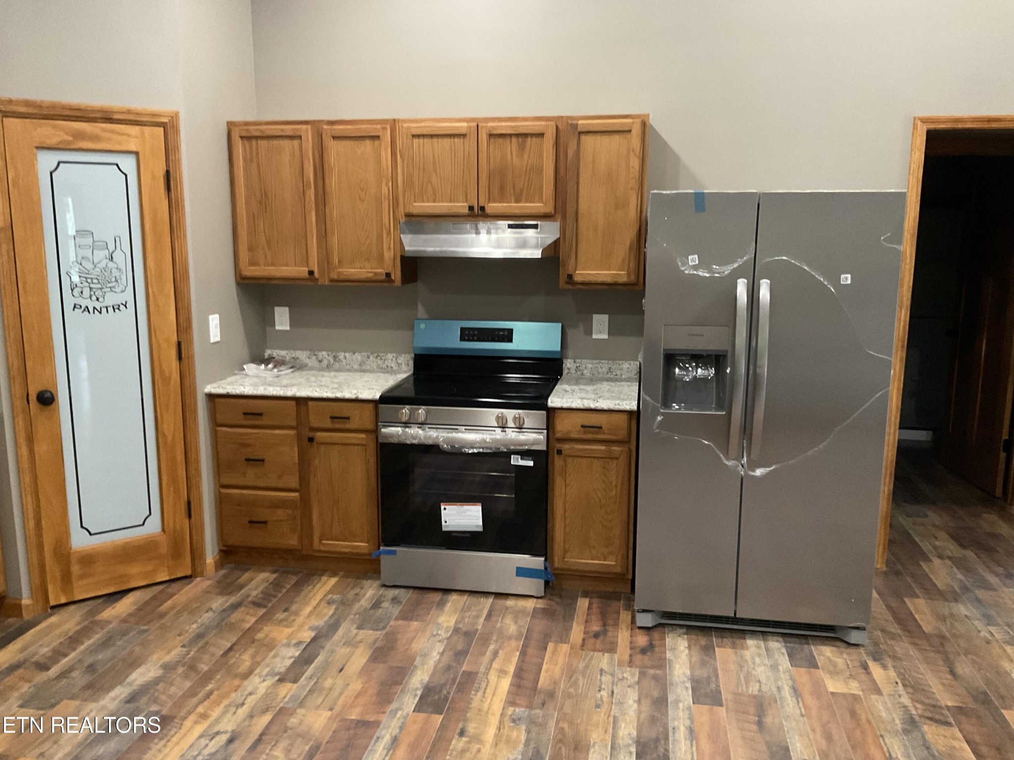 246 Burkemill Road Rockwood, TN 37854 - Photo 3 of 24 a kitchen with stainless steel appliances granite countertop a refrigerator a stove and a sink