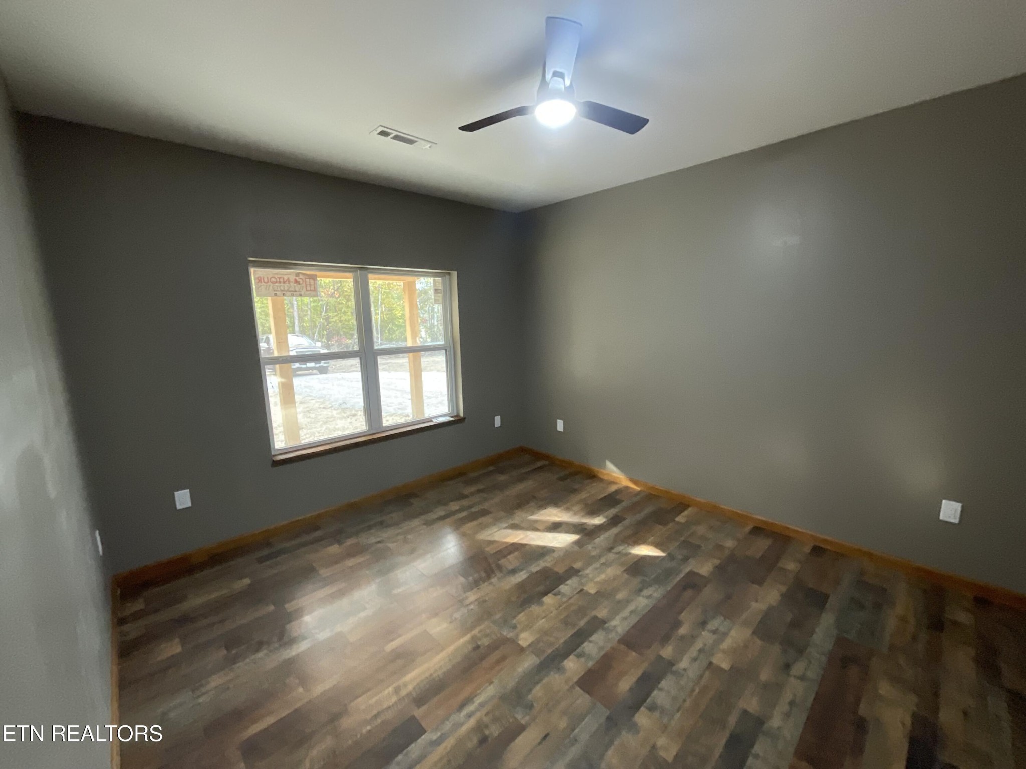 246 Burkemill Road Rockwood, TN 37854 - Photo 10 of 24 en empty room with windows and ceiling fan