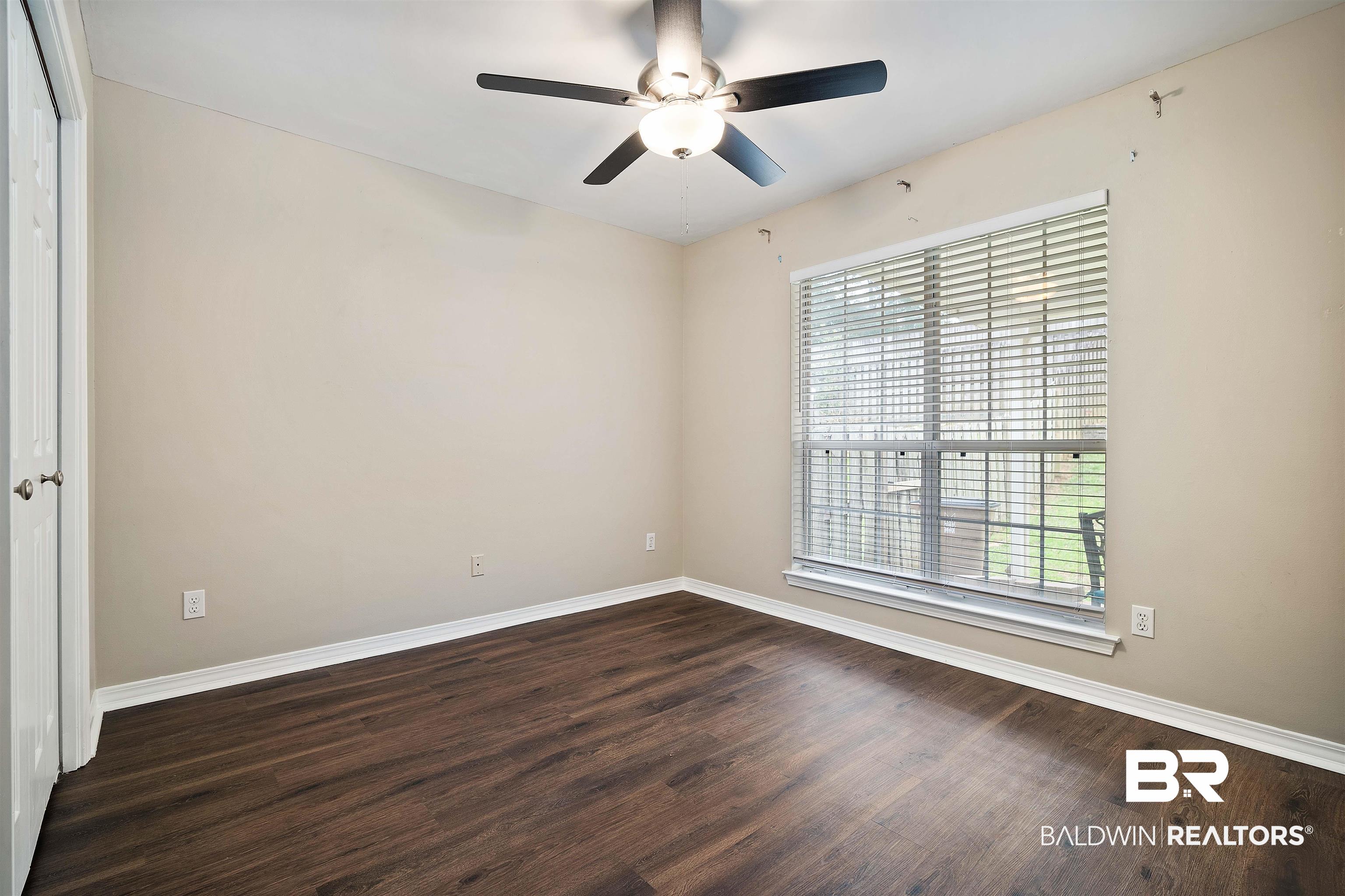 628 Spring Lake Court Mobile, AL 36695 - Photo 15 of 25 Empty room featuring ceiling fan and dark hardwood / wood-style flooring