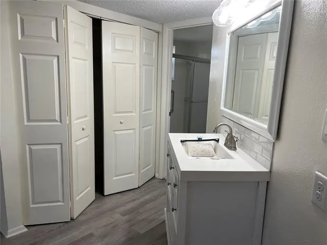 a bathroom with a sink a mirror and shower
