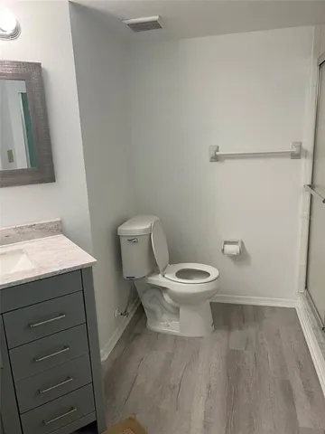 a white toilet sitting next to a bathroom sink