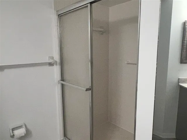 a bathroom with a glass shower door