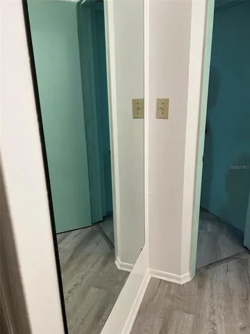 an entryway door with wooden floor