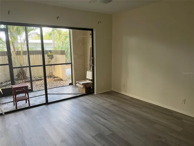 a view of a room with sliding door and wooden floor