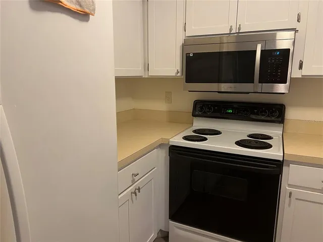 a kitchen with a stove and a microwave