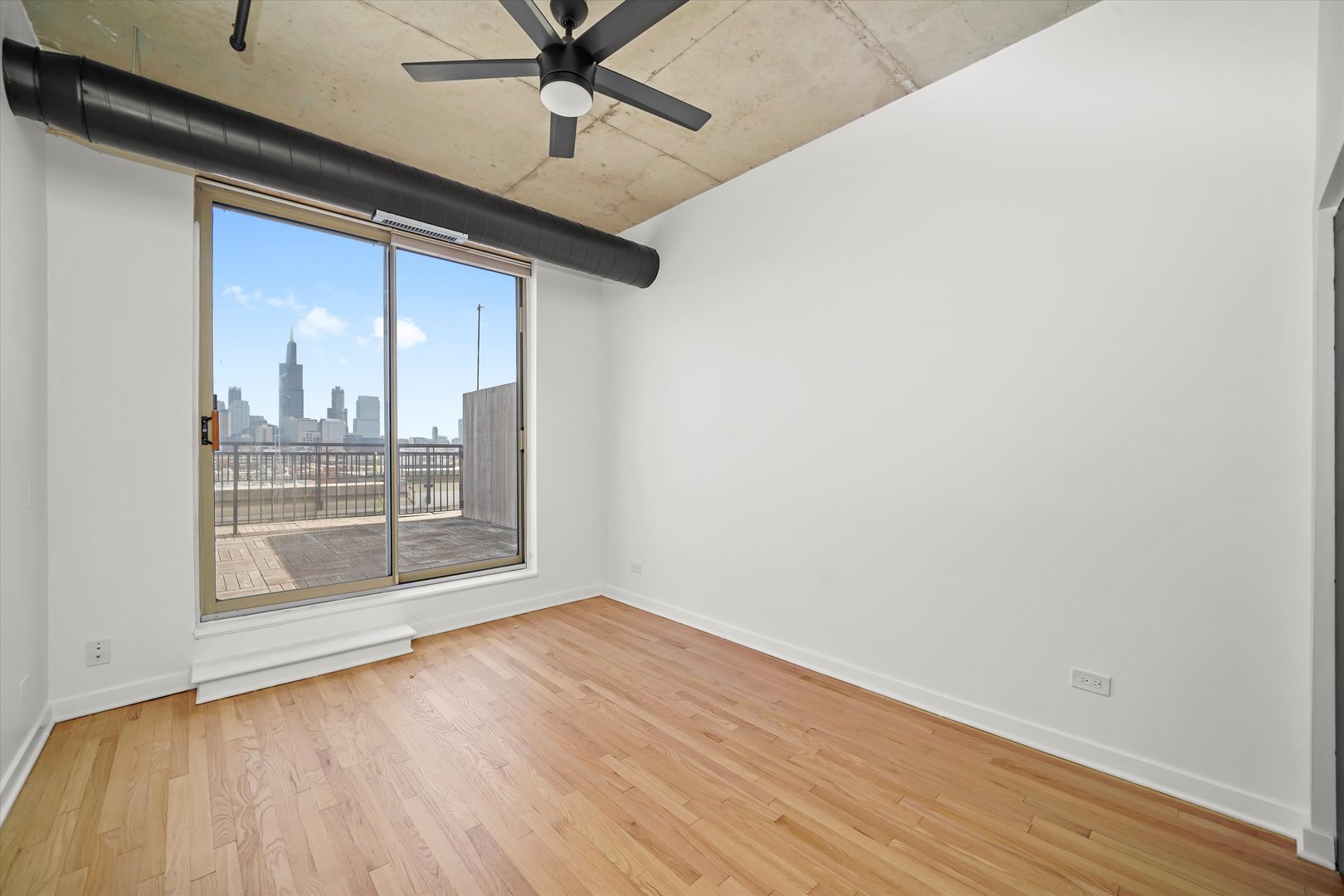 6 South Laflin Street, Unit 910 Chicago, IL 60607 - Photo 17 of 23 a view of a livingroom with wooden floor and a ceiling fan