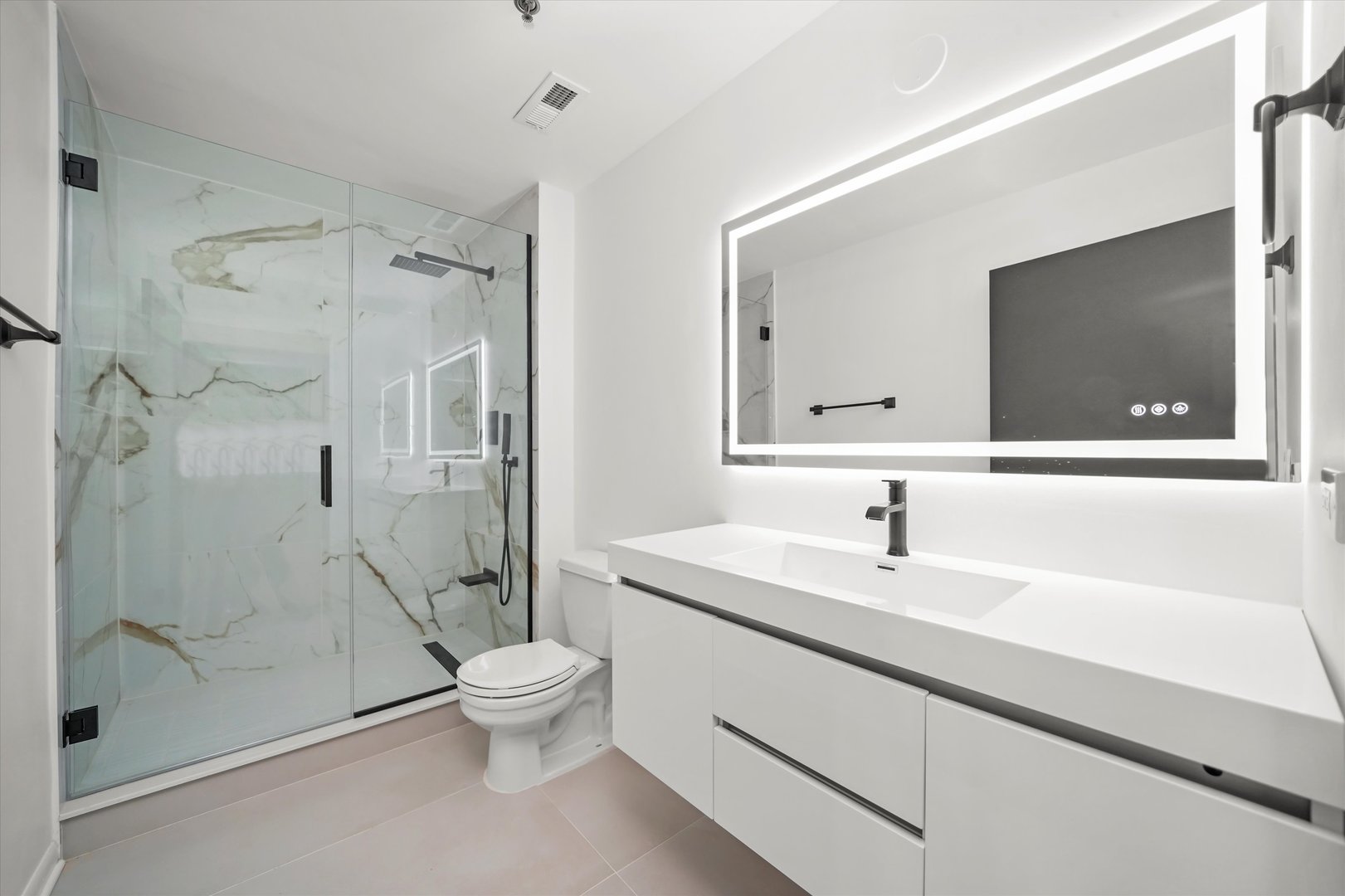 6 South Laflin Street, Unit 910 Chicago, IL 60607 - Photo 18 of 23 a bathroom with a sink a toilet and a large mirror