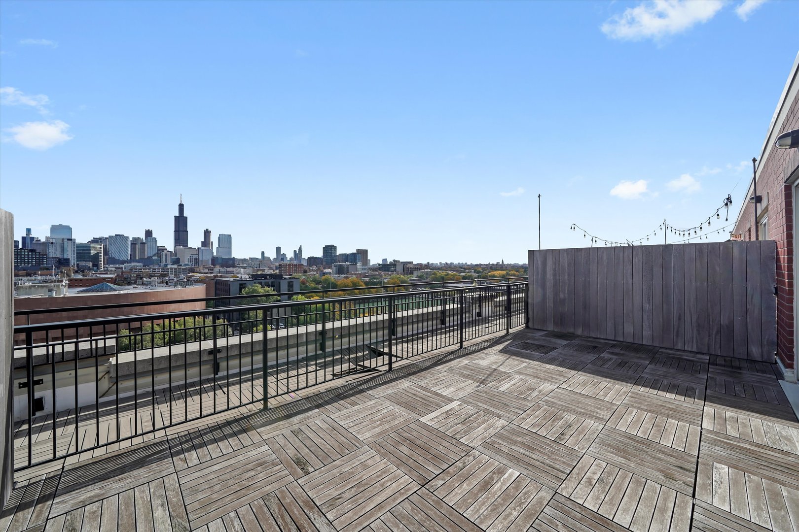 6 South Laflin Street, Unit 910 Chicago, IL 60607 - Photo 3 of 23 a view of a balcony with wooden fence