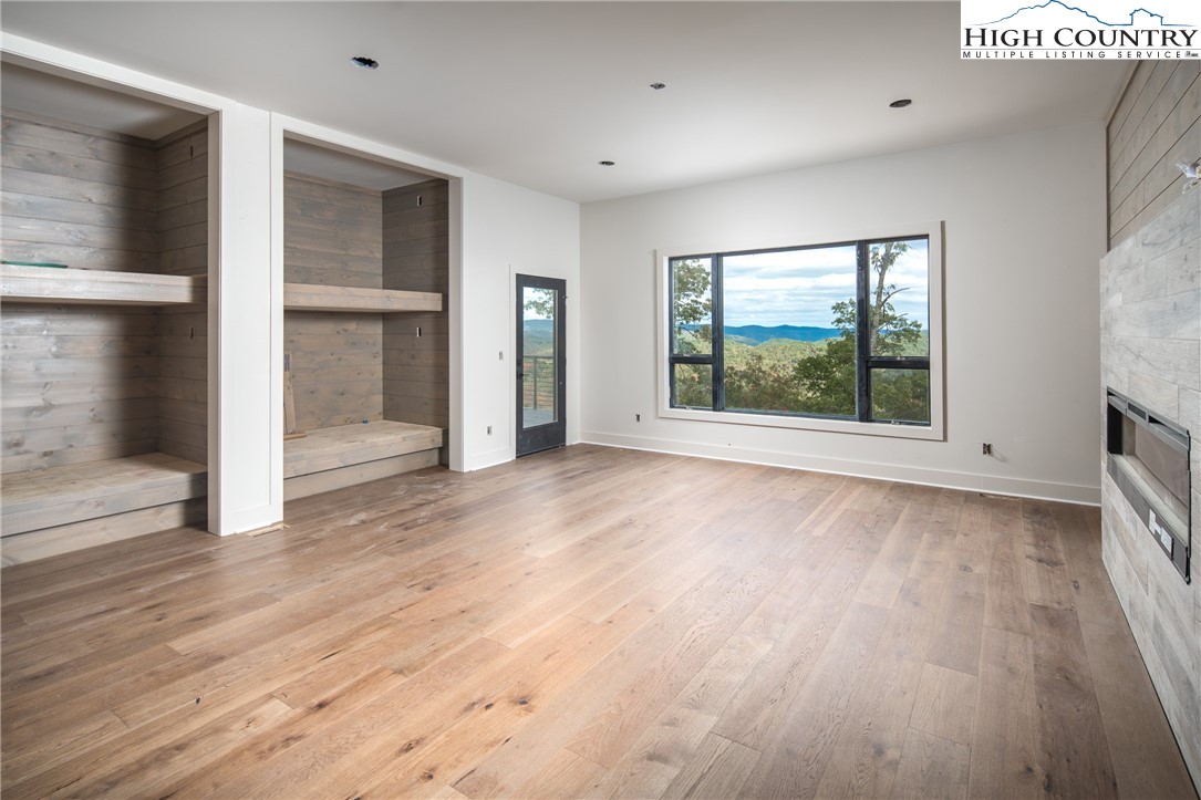 140 Lobelia Lane Boone, NC 28607 - Photo 17 of 31 an empty room with wooden floor and windows