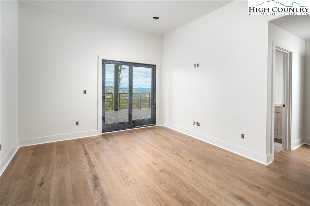 140 Lobelia Lane Boone, NC 28607 - Photo 21 of 31 a view of an empty room with wooden floor and a window