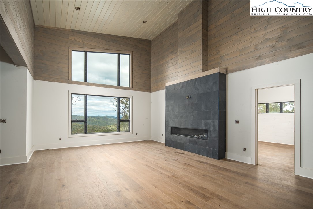 140 Lobelia Lane Boone, NC 28607 - Photo 3 of 31 an empty room with wooden floor and windows