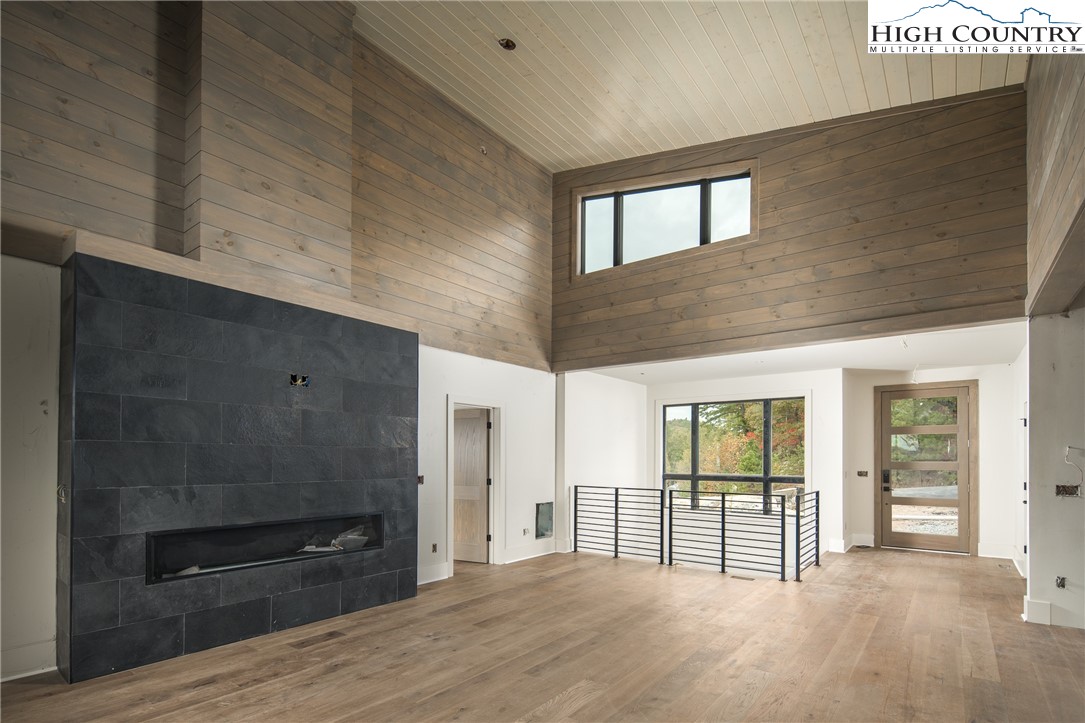 140 Lobelia Lane Boone, NC 28607 - Photo 5 of 31 a view of a hallway with wooden floor and windows