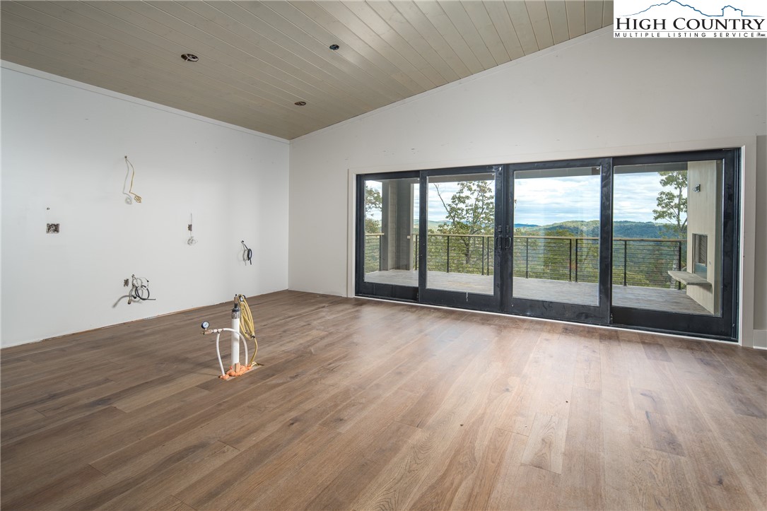 140 Lobelia Lane Boone, NC 28607 - Photo 7 of 31 a view of empty room with wooden floor and fan