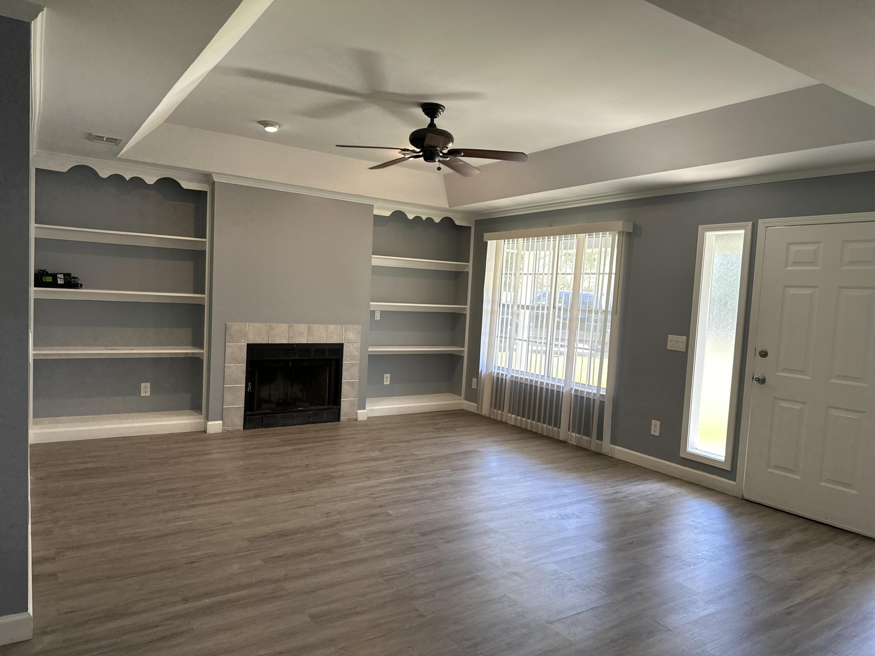 114 Wright Circle Niceville, FL 32578 - Photo 2 of 17 wooden floor in an empty room with a window
