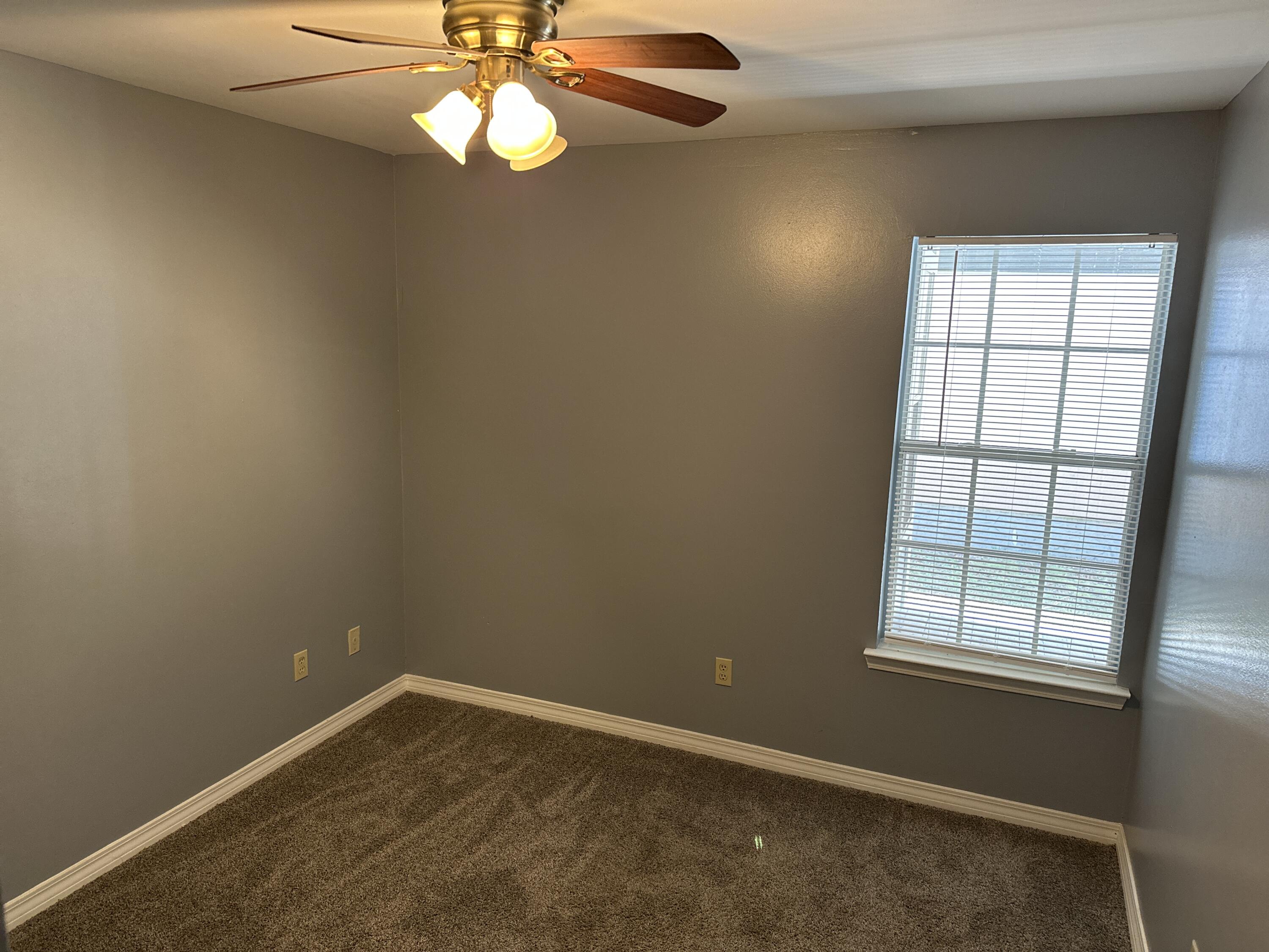 114 Wright Circle Niceville, FL 32578 - Photo 10 of 17 an empty room with windows and fan