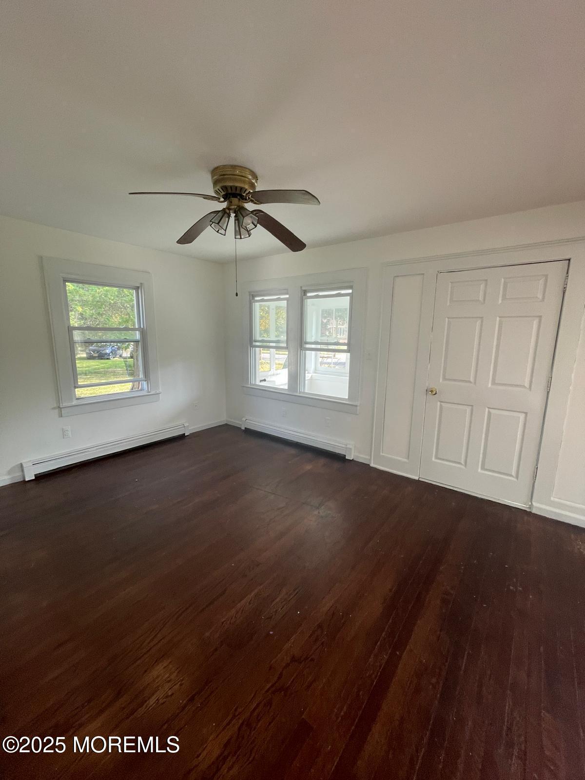 399 Park Avenue, Unit 1 Oakhurst, NJ 07755 - Photo 8 of 12 a view of an empty room with a window and wooden floor