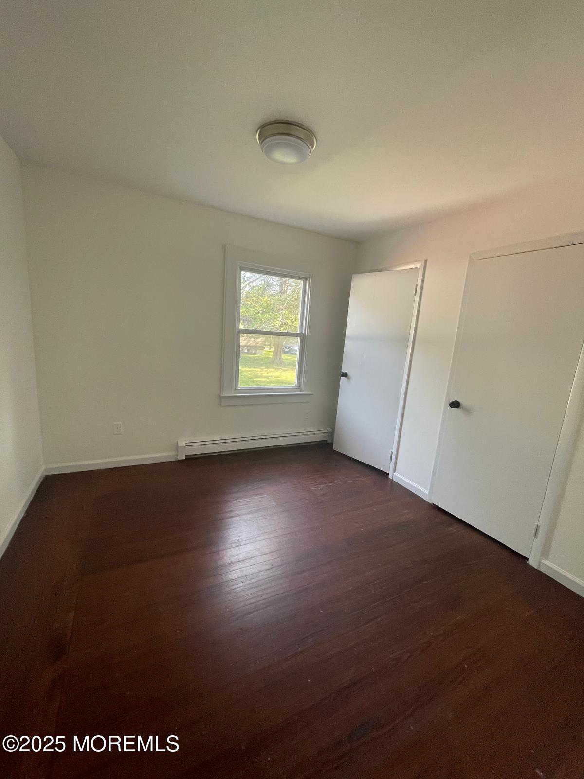 399 Park Avenue, Unit 1 Oakhurst, NJ 07755 - Photo 9 of 12 an empty room with windows