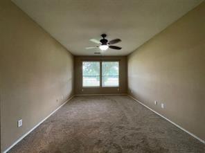 1100 Inland Lane McKinney, TX 75072 - Photo 16 of 24 an empty room with windows and a ceiling fan