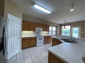 a kitchen with stainless steel appliances granite countertop a sink counter space cabinets and a large window