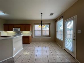 1100 Inland Lane McKinney, TX 75072 - Photo 20 of 24 a kitchen with stainless steel appliances granite countertop a stove a sink and a refrigerator