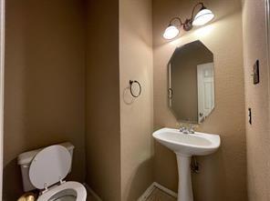 1100 Inland Lane McKinney, TX 75072 - Photo 23 of 24 a bathroom with a toilet sink and mirror