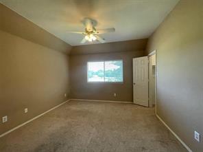 1100 Inland Lane McKinney, TX 75072 - Photo 10 of 24 an empty room with a chandelier fan and windows