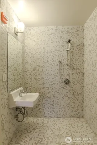 a bathroom with a sink a toilet and a shower