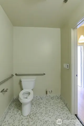 a white toilet sitting next to a bathroom sink