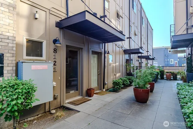 a view of a house with potted plants