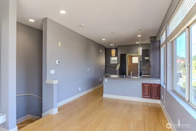 a view of kitchen and hall with wooden floor
