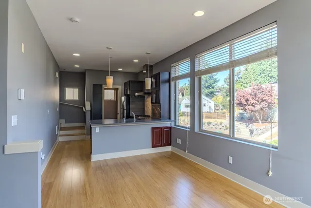 a view of a living room a window and wooden floor