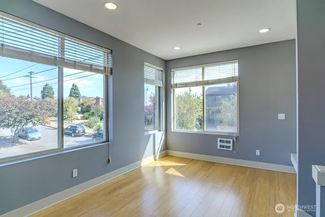 a view of an empty room with a fireplace and a window