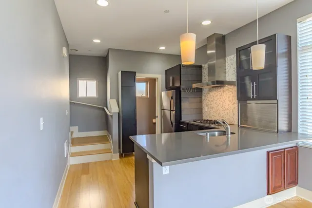 a kitchen with stainless steel appliances a sink stove and refrigerator