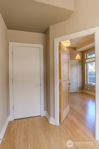 a view of a room with wooden floor and a window