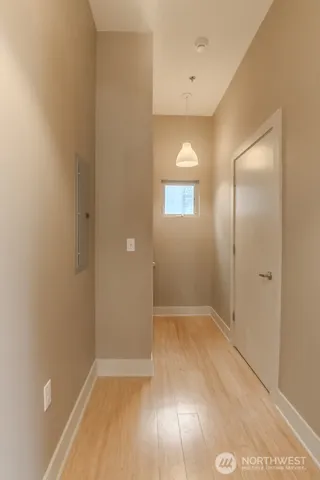 an empty room with closet and windows